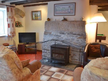 LIVING AREA WITH FEATURE FIREPLACE HOME TO A WOODBURNER