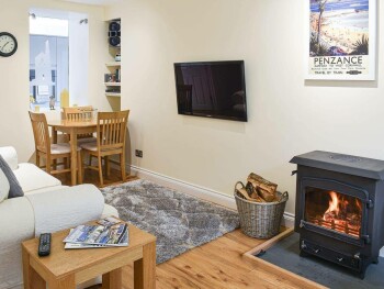 WELCOMING LIVING AND DINING ROOM WITH WOOD BURNER