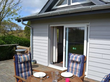 SUNNY DECKED AREA WITH TABLE AND CHAIRS