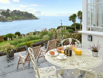 SIT OUT ON THE TERRACE AND GAZE OUT TO SEA