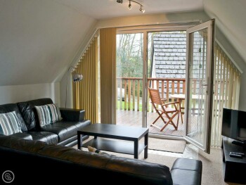 LOUNGE AREA WITH PATIO DOORS LEADING ONTO BALCONY