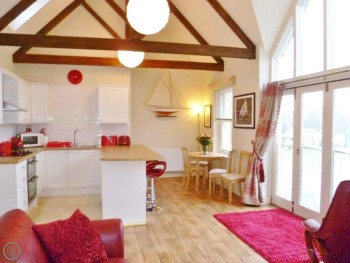 THE MAIN OPEN PLAN LIVING AREA WITH A STRIKING FEATURE WINDOW WITH JULIET BALCONY