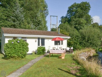 DETACHED LODGE IS IN AN ATTRACTIVE SETTING BESIDE A BABBLING BROOK