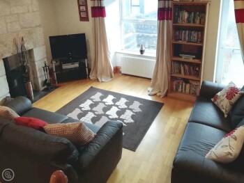 WOOD-FLOORED LIVING AREA WITH WOOD BURNER